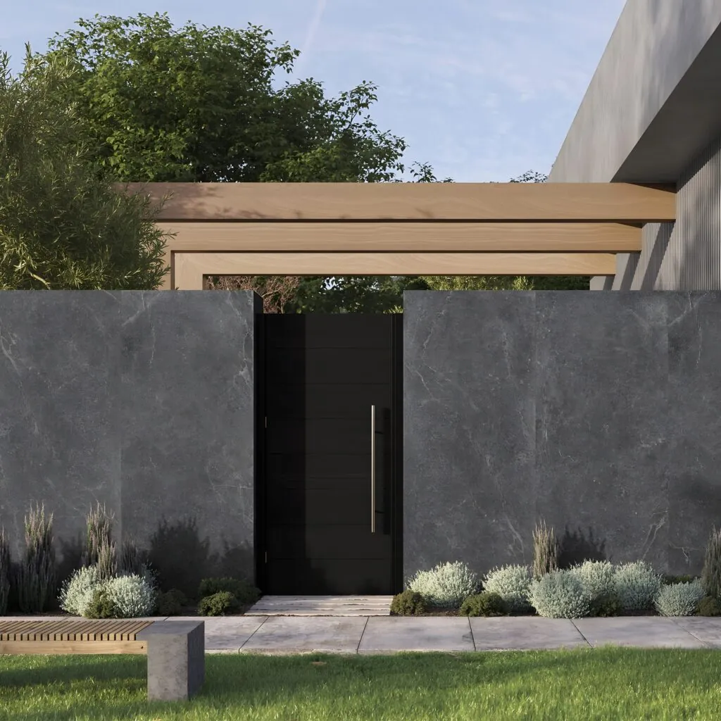 Muro exterior con porcelánico Bleuemix negro en gran formato y jardín
