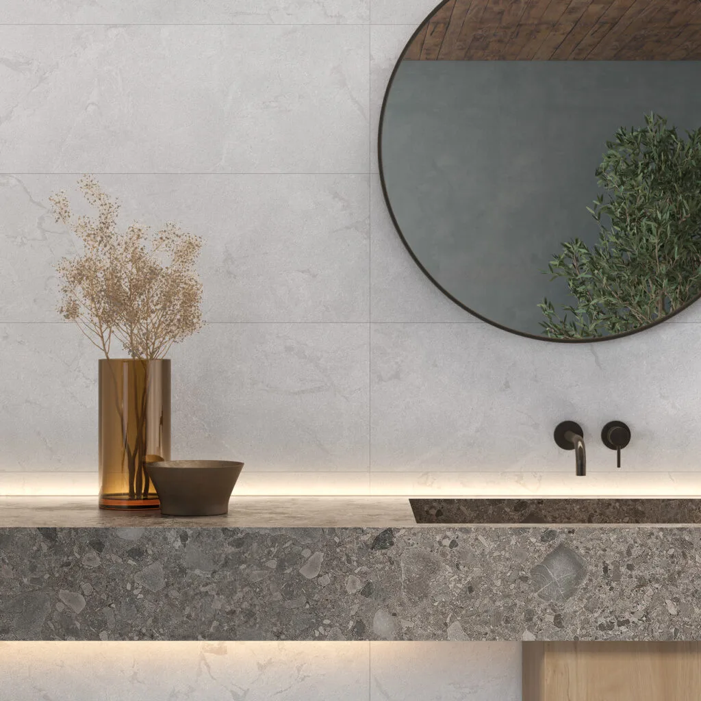 Lavabo de piedra con revestimiento Eternia blanco y espejo redondo negro