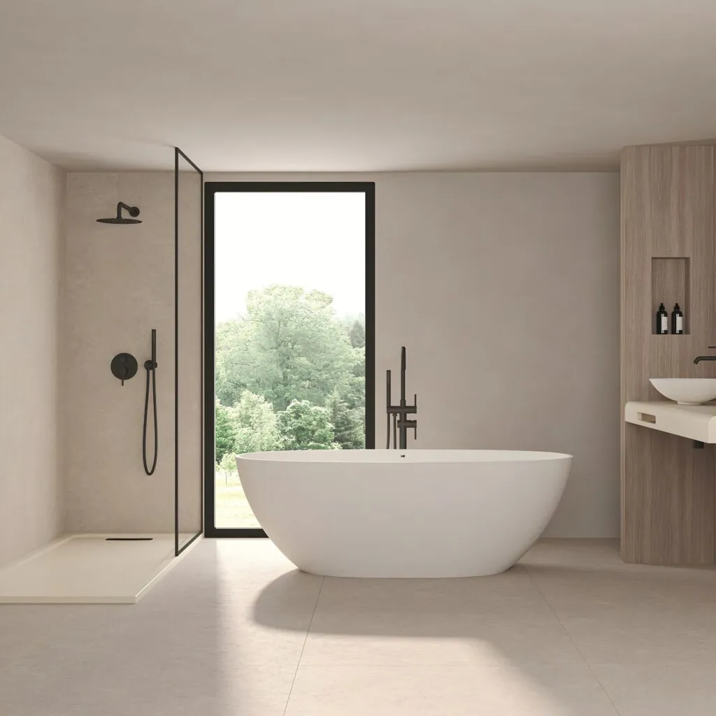 Bañera exenta blanca junto a ducha acristalada con ventana al bosque