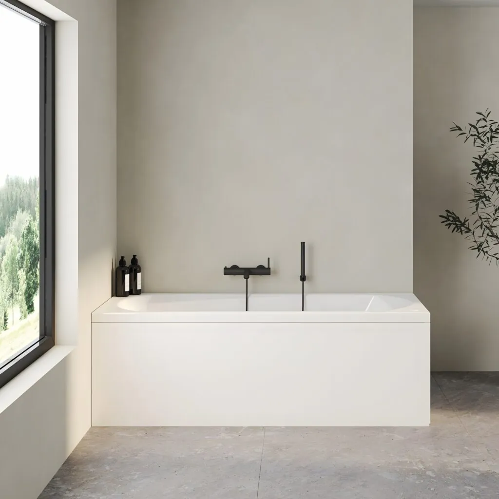 Bañera rectangular con faldón blanco y grifería negra mural